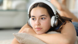 Pensive woman with headphone listening to music