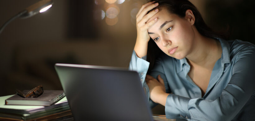 Worried tele worker checking laptop in the night
