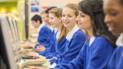 Students sitting in row during IT lesson