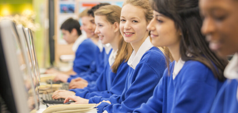 Students sitting in row during IT lesson