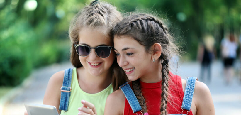 Two girls looking at a tablet