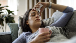 Sick woman lying in bed