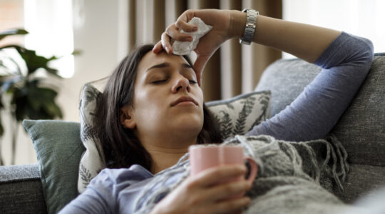Sick woman lying in bed