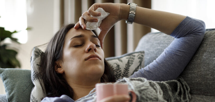 Sick woman lying in bed