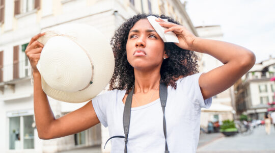 Black woman suffering and sweating for hot weather