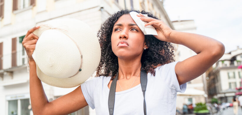 Black woman suffering and sweating for hot weather