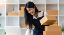 Startup SME small business entrepreneur of freelance Asian woman using laptop and box to receive and review orders online to prepare to pack sell to customers, online sme business ideas