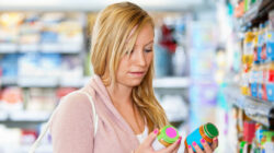 Young woman holding jar in the supermarket