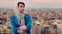 Full Length Of Woman Standing Against Buildings In City