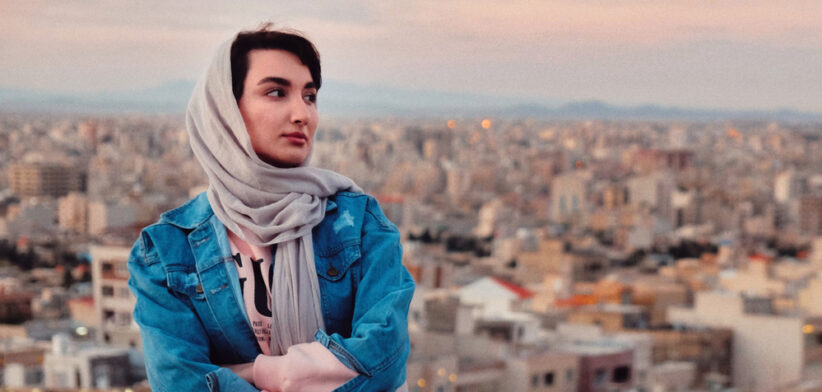 Full Length Of Woman Standing Against Buildings In City