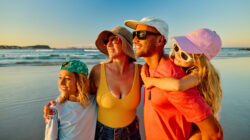 Family enjoying summer vacations at the beach in Australia