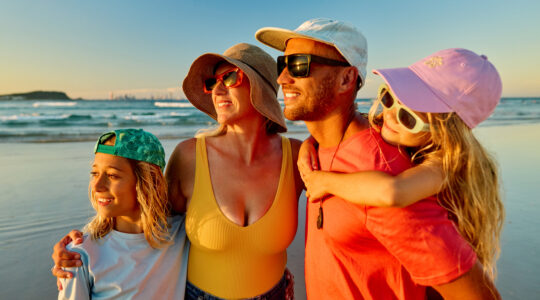 Family enjoying summer vacations at the beach in Australia