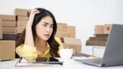 Asian woman think hard serious working laptop computer at home selling online start up small business owner, e-commerce ideas concept.