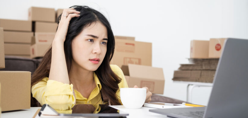 Asian woman think hard serious working laptop computer at home selling online start up small business owner, e-commerce ideas concept.