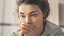 Sad young woman dealing with loss and psychological trauma