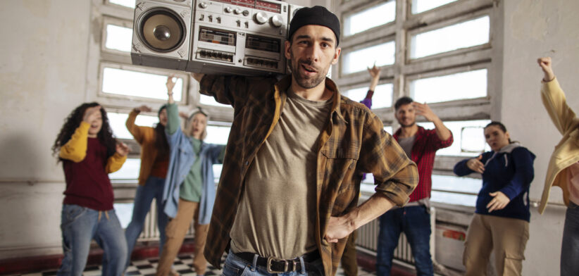 Man with boombox leads group dance session.