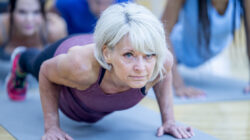 Senior Woman in Fitness Class in a Plank Pose stock photo