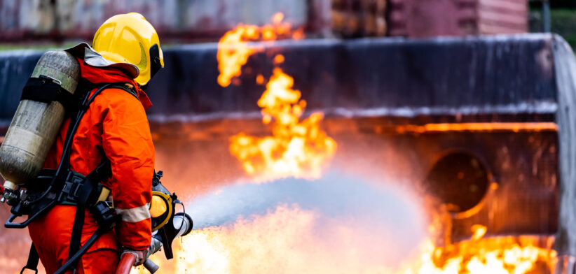Firefighters spraying down fire flame from oil tanker truck accident