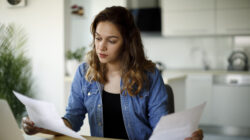 Serious young woman working at home