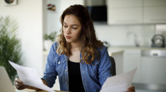 Serious young woman working at home