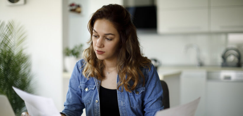 Serious young woman working at home