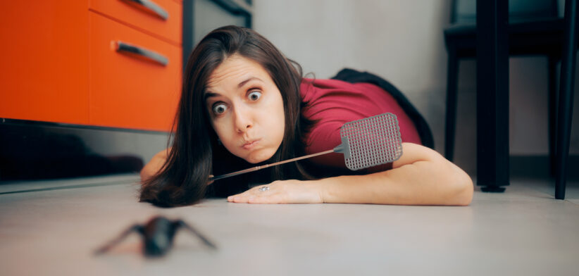 Woman Following a Big Insect on the Kitchen Floor