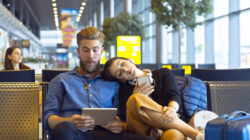 Young couple waiting for flight in airport area