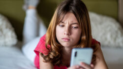 portrait of a teenage girl looking at the phone