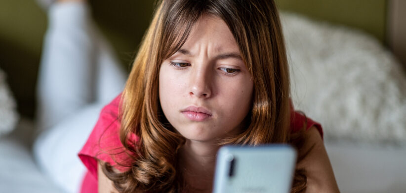 portrait of a teenage girl looking at the phone