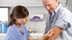 Doctor Giving Male Patient Injection