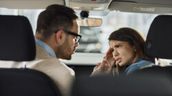 Young couple arguing inside of a car.