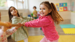 Children playing a game of tug of war in playroom