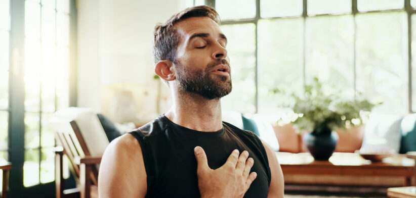 Yoga, man and breathe meditation in home, house or living room floor for energy, fitness or mental health. Relax, stress relief and zen person with mindfulness for pilates, spiritual healing or peace