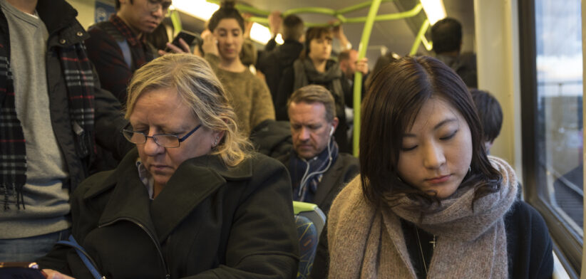 Commuters on metro train in Melbourne, Australia