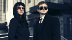 Young fashion business couple against office building
