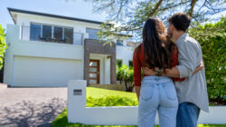 Couple standing outside a home
