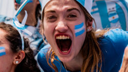 Portrait of a passionate female fan celebrating during an Argentine football match in the stands