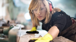 Blonde woman cutting a plank
