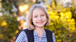 School girl walking home from school with backpack