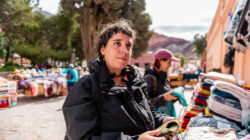 Mid adult tourist looking at souvenirs on a street market in historic district of Purmamarca, Argentina