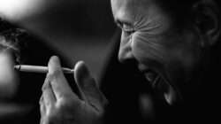 Black And White Close Portrait Of Woman Smoking Cigarette With Emotion