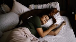 Girl sleeping with her dog.