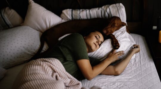 Girl sleeping with her dog.
