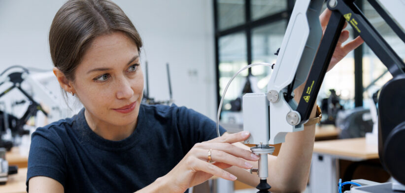 Female automation machine engineer student study and inspection control robot machine in university workshop. ai robot technology new innovation trend of manufacturing in industry 5.0