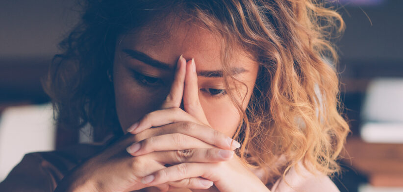 Tired Young Woman Leaning Head on Hands