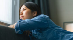 Young woman sitting on sofa