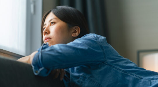 Young woman sitting on sofa