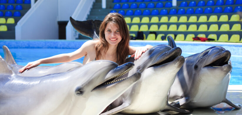woman with dolphins in the Dolphinarium