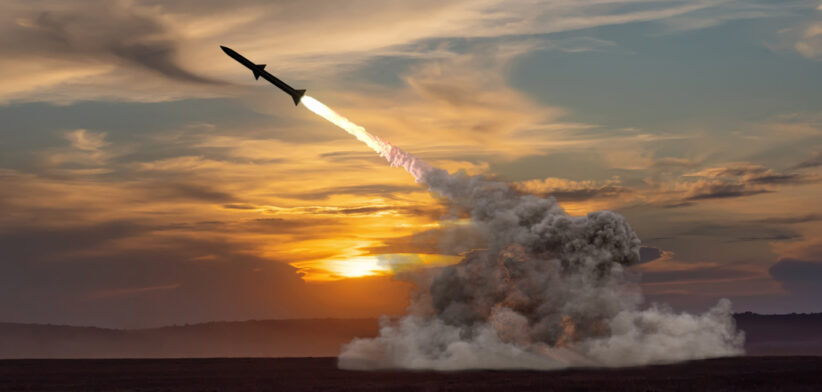 rocket launch against the background of the evening field, the setting sun.