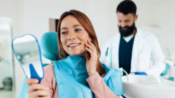 Woman admiring her smile after dental checkup at the dentist’s office